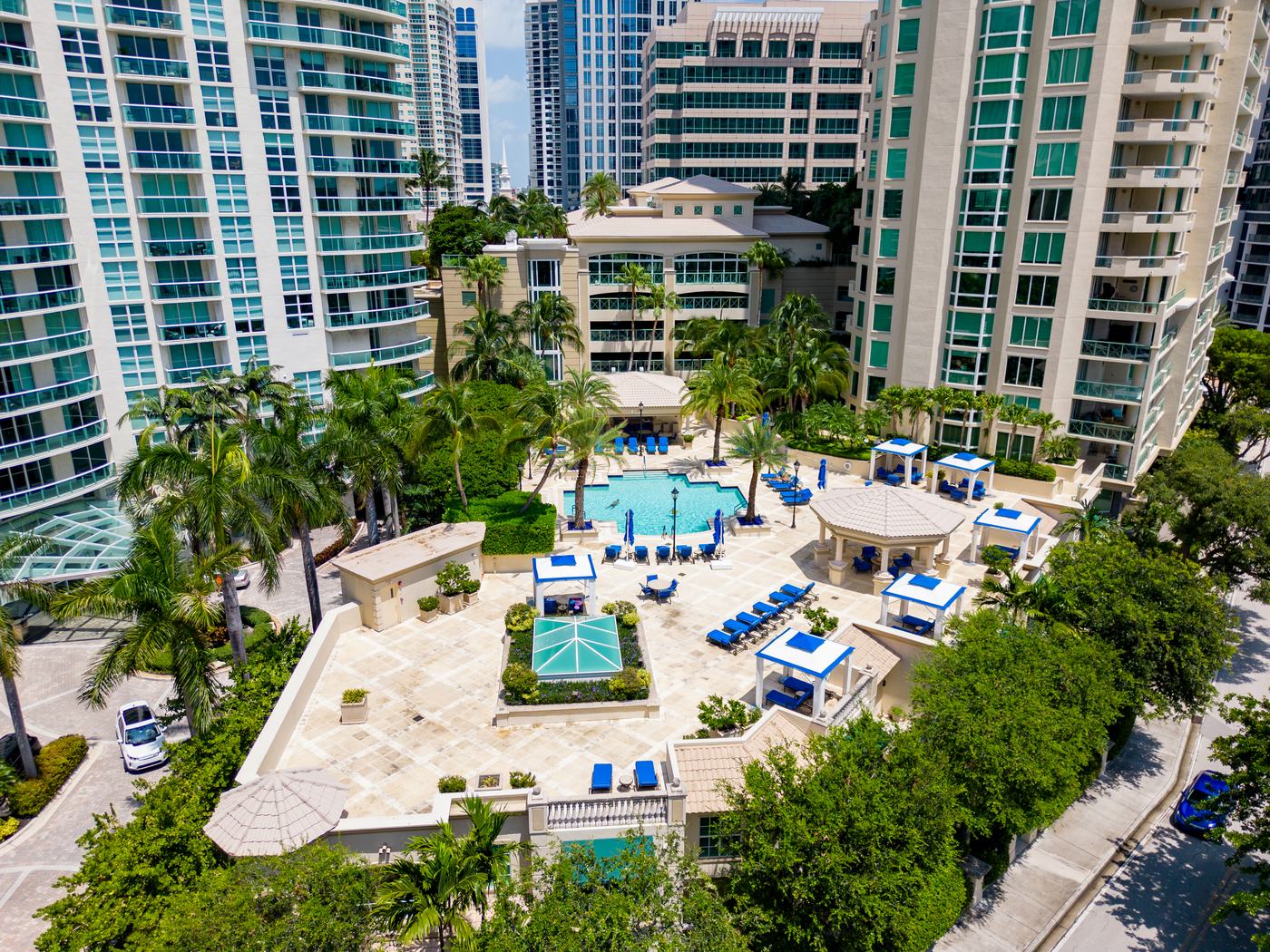 High-rise condominium towers around a pool terrace in Florida